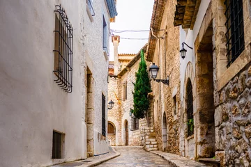 View of the a small street and alleys of Sitges, medieval Spanish town in the coast of Catalonia. Spanish architecture and tourism