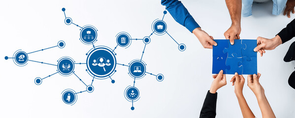 A dynamic visual representation of teamwork showcasing hands collaborating with puzzle pieces. The...