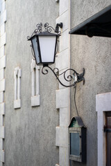 View of a vintage wall-mounted street lamp on a stone wall