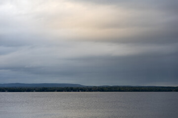 Cloudy sky and river during sunset. Ottawa river in Canada.