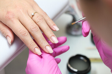 Woman's hand manicure background. Nail care and beauty treatment in a professional salon. Elegant...