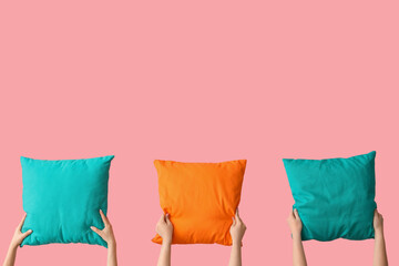 Women with bright pillows on pink background