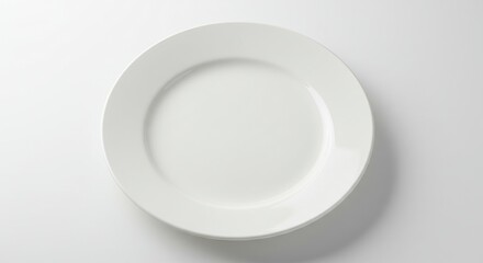 A simple overhead shot of a plain white ceramic plate centered on a bright white background surface area