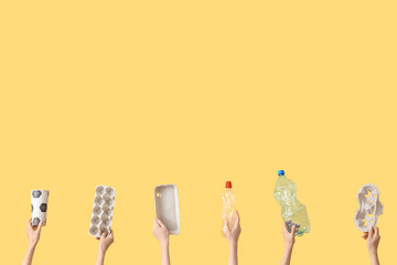 Female hands with garbage on yellow background. Recycling concept