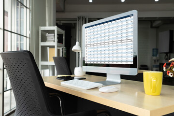 Accounting software on computer screen showing financial statement spreadsheets and account balance...
