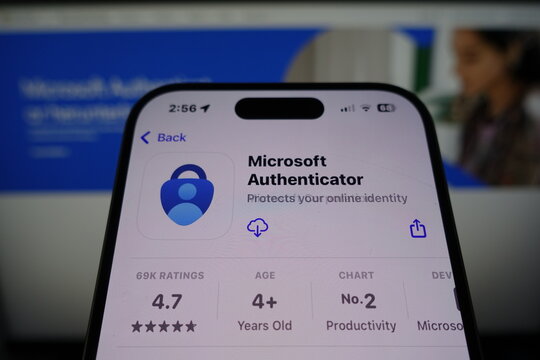 Kiel, SH, Germany March 27 2025: Microsoft Authenticator by Microsoft ready for download in the App Store on smartphone screen with company website in background