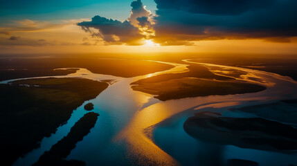 Aerial view of river winding through land under a vibrant sunset with clouds in the sky above it