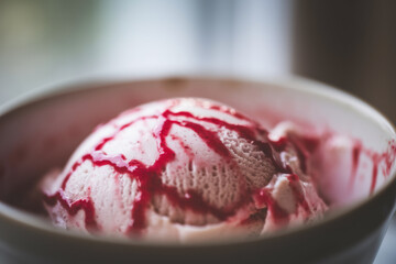 Decadent Strawberry Ice Cream Drizzled with Sweet Red Sauce in a Whimsical Bowl
