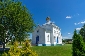 A white-stone church with a golden dome on the eve of Easter.