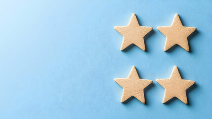 Four Tan Star Shapes on Textured Blue Surface with Scattered Glitter for Decorative Design