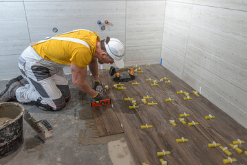 Tiling work a floor in the bathroom. 
