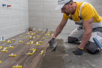 Tiling work a floor in the bathroom.  