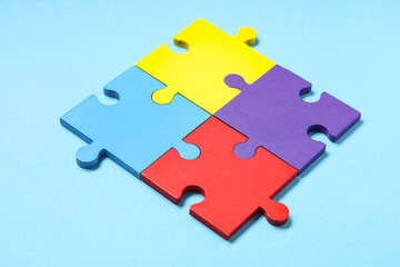 Colorful puzzle pieces on blue background. Autistic disorder concept