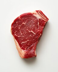 Obraz premium Raw beef steak isolated on white background showcasing marbled texture perfect for grilling or cooking recipes
