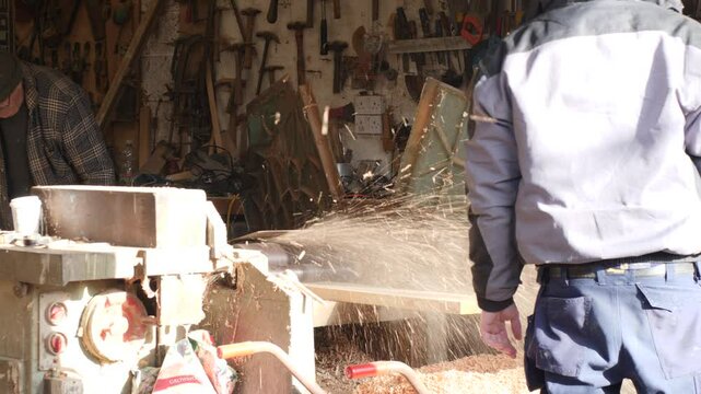 Planing Pine wood plank with industrial planer thicknesser