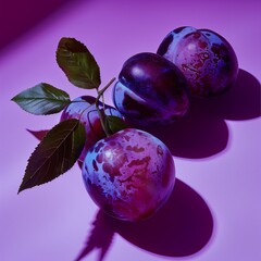 A close-up of vibrant plums with deep purple and blue hues on a smooth purple background. Strong lighting creates bold shadows, enhancing their glossy texture and rich details.