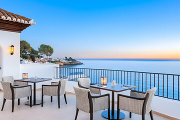 Serene oceanfront patio dining at sunset