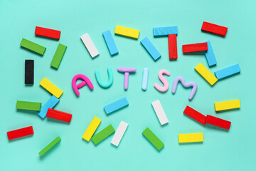 Composition with word AUTISM and colorful building blocks on color background