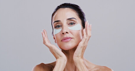 Cosmetics, woman and eye patches in studio for wrinkle reduction, anti aging treatment and hyaluronic acid. Mockup, mature person and portrait with beauty product for self care on white background