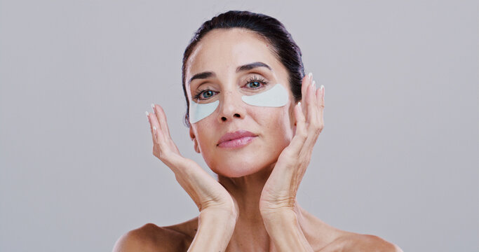 Cosmetics, woman and eye patches in studio for wrinkle reduction, anti aging treatment and hyaluronic acid. Mockup, mature person and portrait with beauty product for self care on white background