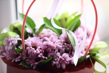 A bouquet of purple flowers placed on a window sill, ready for display or decoration.