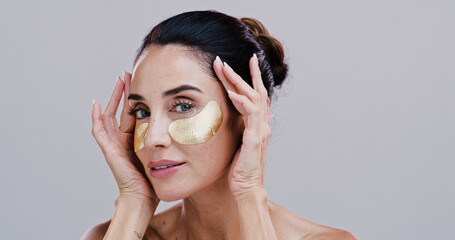 Beauty, woman and eye patches in studio for wrinkle reduction, skincare treatment and hyaluronic acid. Mockup, mature person and portrait with cosmetics product for dark circles on white background
