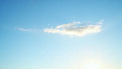 Obraz premium Cloud floating in a serene blue sky. Soft sunlight touches the cloud's edges