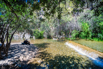 Relaxation from the summer heat at the Algar waterfalls (Les Fonts de l'Algar). Located in Callosa de Ensarria, Alicante, Spain.