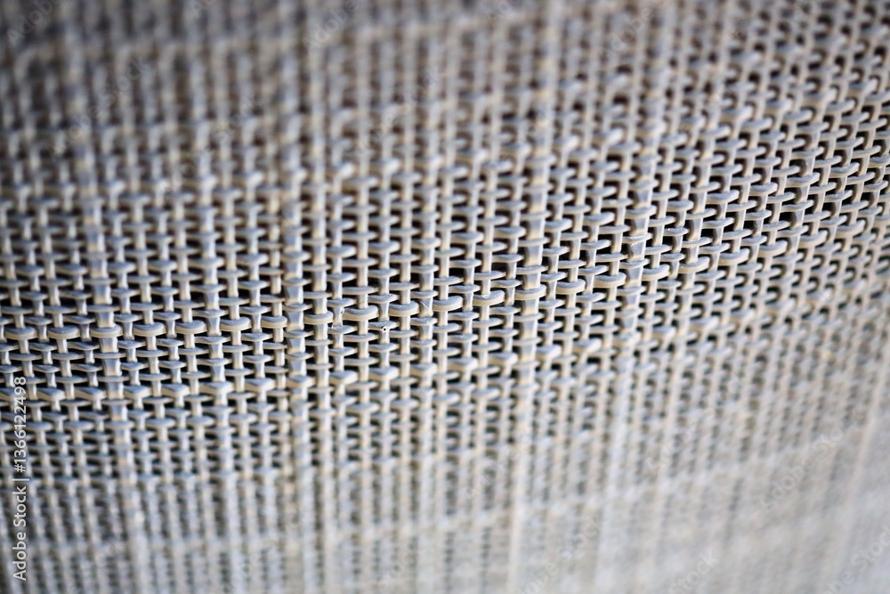 Poster close-up shot of a metal mesh curtain with intricate details and texture.
