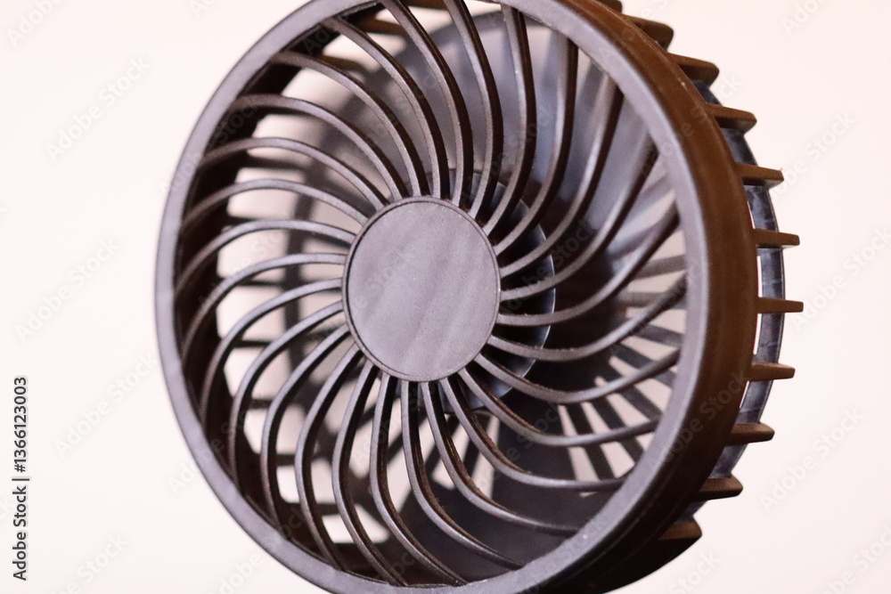 Poster A detailed view of a fan mounted on a plain white background, ideal for use in graphic design or as a texture.