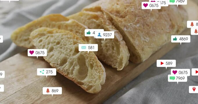 Sliced bread on wooden board with animation of social media icons floating