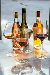 Different types of wine in glasses - red, white, rose and amber. Wine tasting in a bar or restaurant.