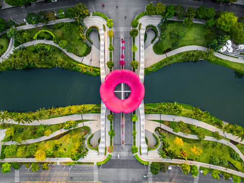 green urban tropical park with creative flower sculpture, Sala district, Ho Chi Minh city, aerial drone view