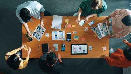 Top view of smart software developer planning software development. Skilled programmer team brainstorming and designing Ux UI design for mobile phone interface or digital creative design. Convocation.