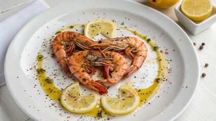 Shrimp dish, with spices, on a white background, in a white plate