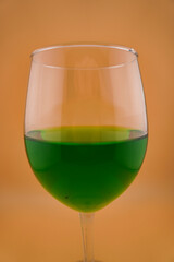 Colored water dropping into a wine glass filled with water.