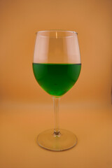 Colored water dropping into a wine glass filled with water.