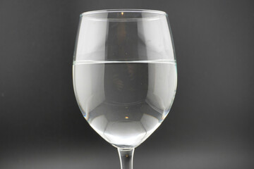 Colored water dropping into a wine glass filled with water.