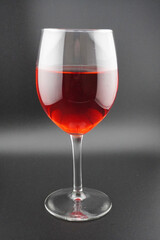 Colored water dropping into a wine glass filled with water.