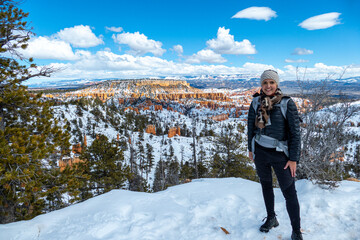 Beautiful hiker in front of panorama landscape of pinnacles of Bryce Canyon National Park covered...