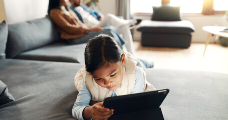 Home, child and girl with tablet for streaming, watch movies and online game with technology....