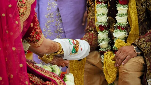  The Indian Hindu Rituals that performed during holy wedding ceremony. Bride and groom holding each others hands. Close up shot of part of wedding ceremony