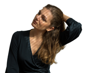 Portrait of a young beautiful girl in a room on a background of a gray wall