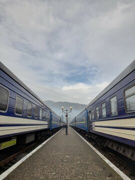 Two trains on the platform with a view of the Carpathian Mountains. Rakhiv Transcarpathia