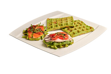 Belgian waffles with spinach on a white plate. Fish sandwiches, chicken sandwiches. Healthy eating. Side view, isolated on white