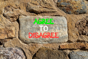Agree to disagree symbol. Concept words Agree to disagree on beautiful grey stone wall. Beautiful...
