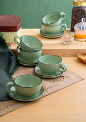Ceramic teacup and saucer set on kitchen table
