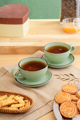 Ceramic teacup and saucer set on kitchen table