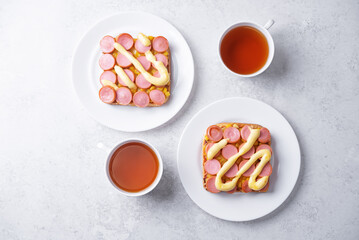 Cheese corn sausages baked sandwich in a plate