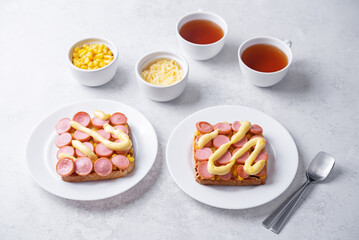 Cheese corn sausages baked sandwich in a plate